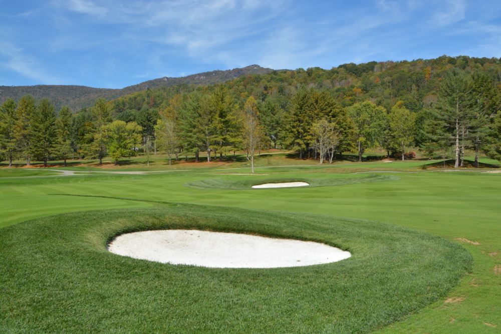 an artificial grass putting green with an artificial grass sand bunker in the front and behind it