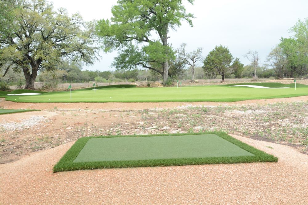 artificial turf used in a tee line for golf chipping to an artificial grass putting green