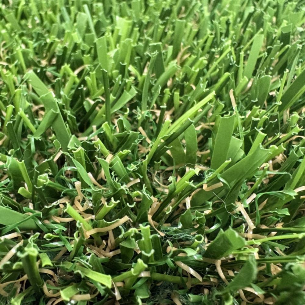 Close-up of artificial grass turf, featuring natural color variation and durable fibers for residential lawns, commercial landscapes, and sports applications by Southwest Greens. Close-up of artificial grass turf, featuring natural color variation and durable fibers for residential lawns, commercial landscapes, and sports applications by Southwest Greens.
