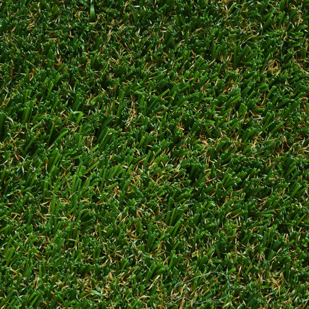 Close up image of green artificial grass with some brown strands. Close up image of green artificial grass with some brown strands.